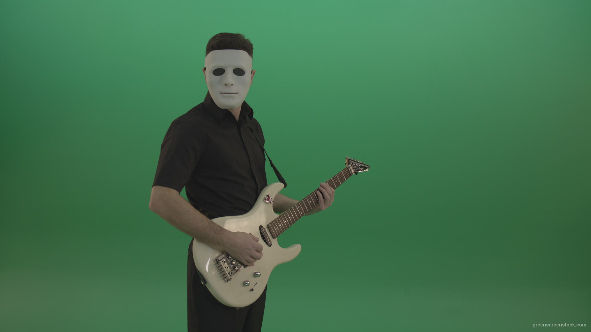 Rock-man-in-white-mask-and-black-wear-playing-guitar-isolated-on-green-screen-in-side-view_001 Green Screen Stock