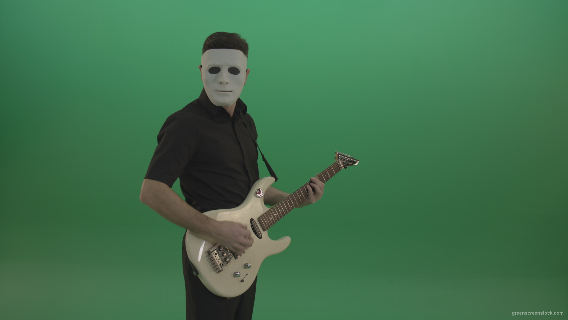 Rock-man-in-white-mask-and-black-wear-playing-guitar-isolated-on-green-screen-in-side-view_002 Green Screen Stock