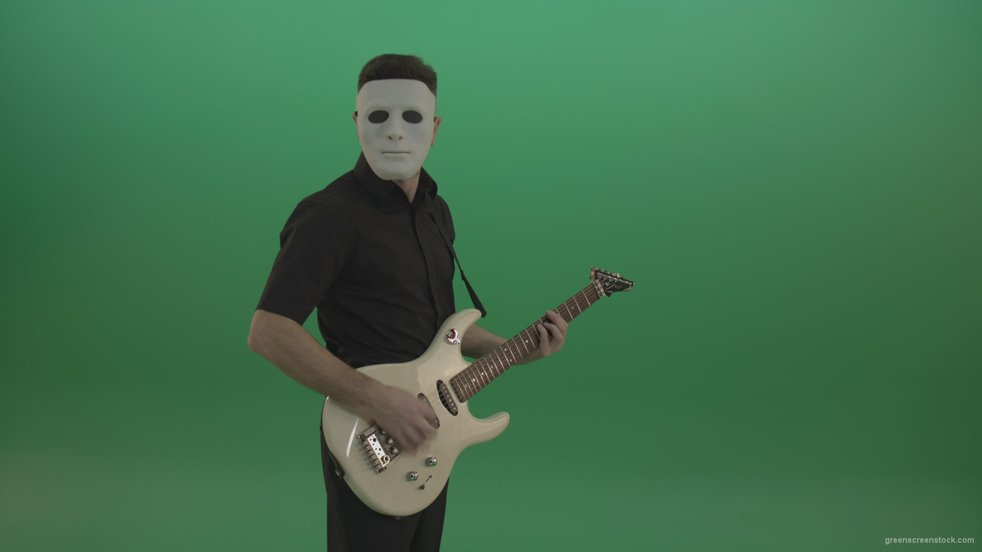 Rock-man-in-white-mask-and-black-wear-playing-guitar-isolated-on-green-screen-in-side-view_006 Green Screen Stock