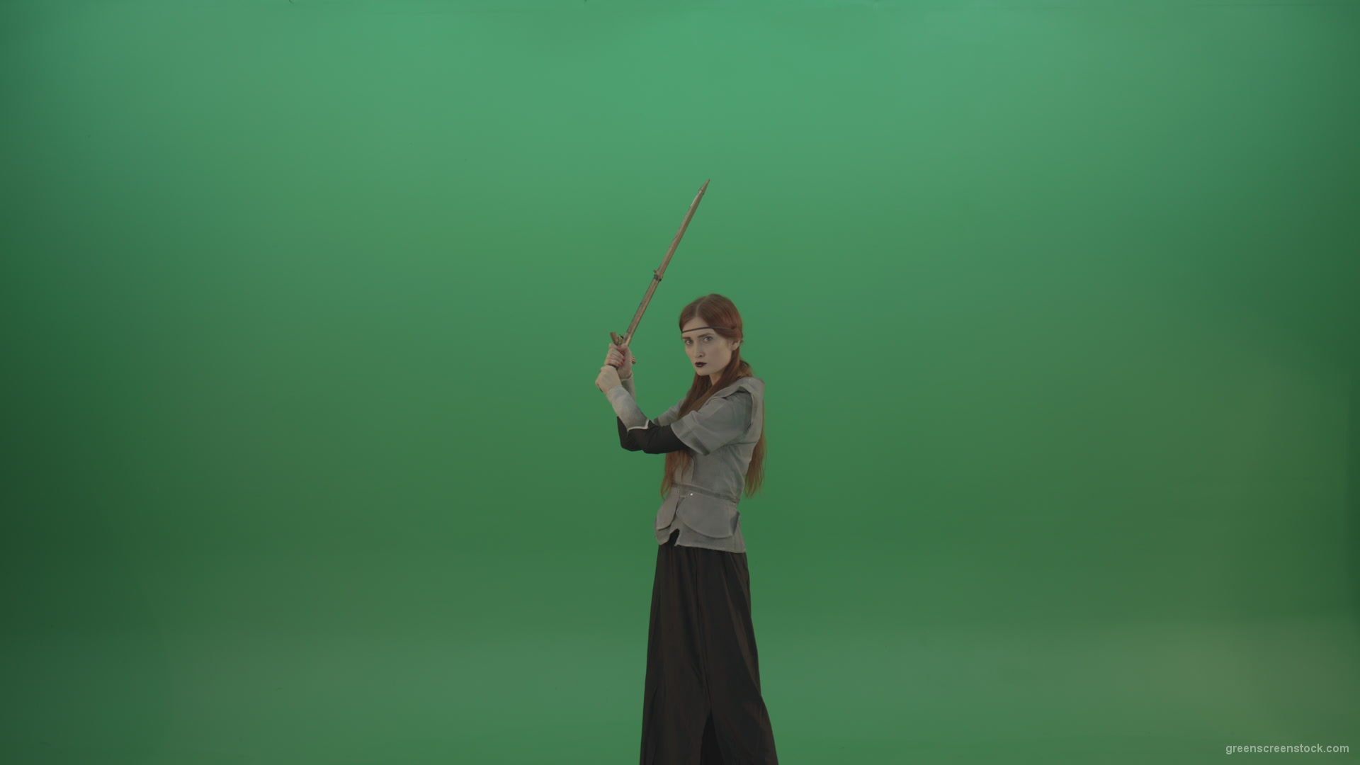 Swinging-on-a-green-background-with-a-sword-the-girl-gracefully-shows-her-strength_001 Green Screen Stock