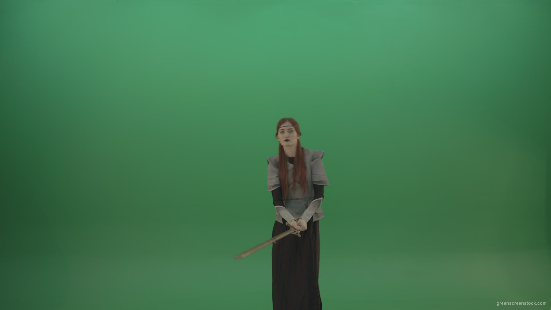 Swinging-on-a-green-background-with-a-sword-the-girl-gracefully-shows-her-strength_006 Green Screen Stock
