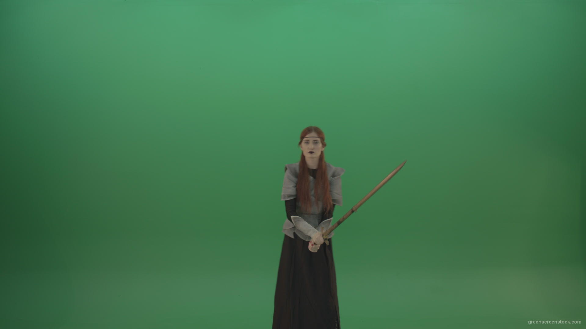 Swinging-on-a-green-background-with-a-sword-the-girl-gracefully-shows-her-strength_007 Green Screen Stock