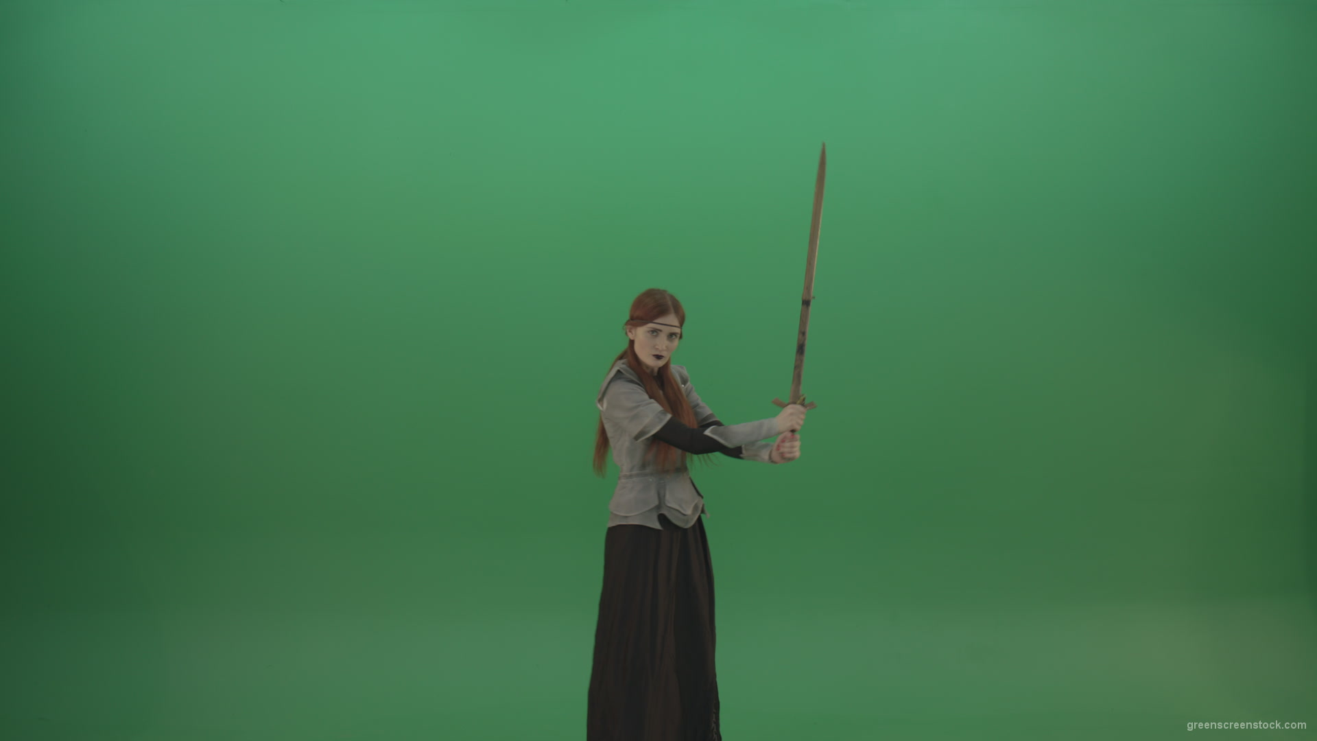 Swinging-on-a-green-background-with-a-sword-the-girl-gracefully-shows-her-strength_008 Green Screen Stock