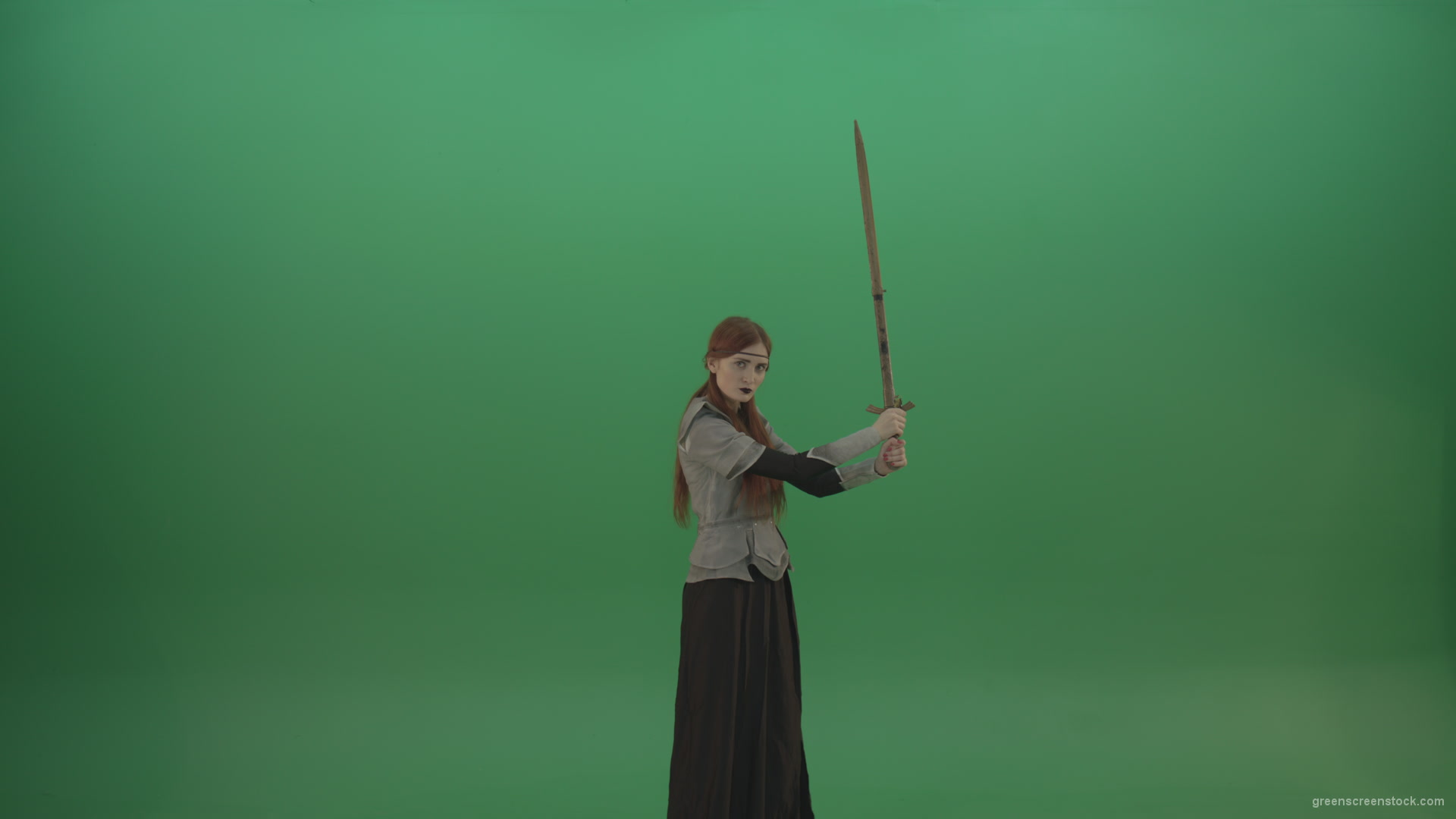 Swinging-on-a-green-background-with-a-sword-the-girl-gracefully-shows-her-strength_009 Green Screen Stock