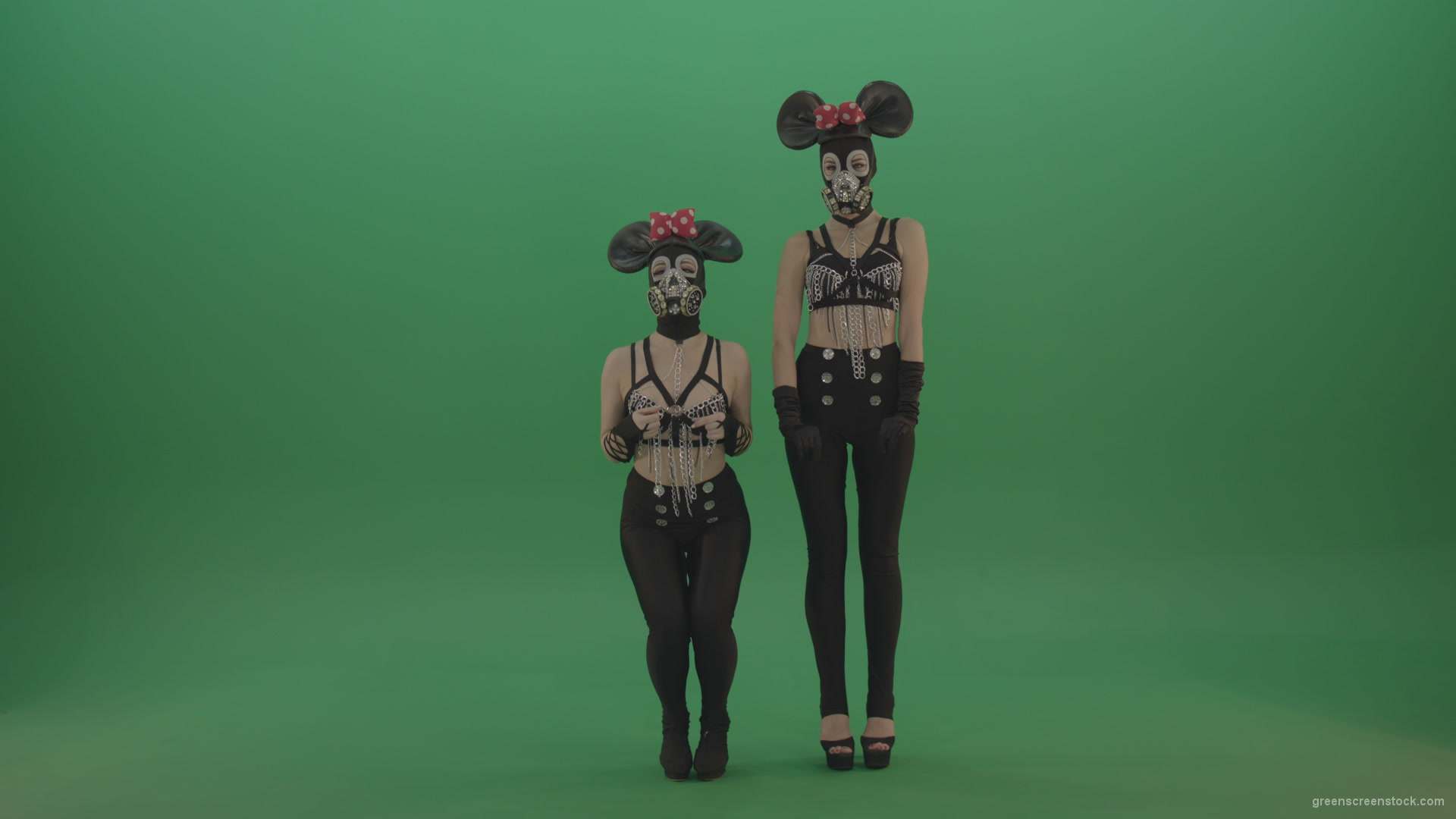 Two-girls-dressed-in-Mickey-Mouse-sit-squarelyon-green-screen_001 Green Screen Stock
