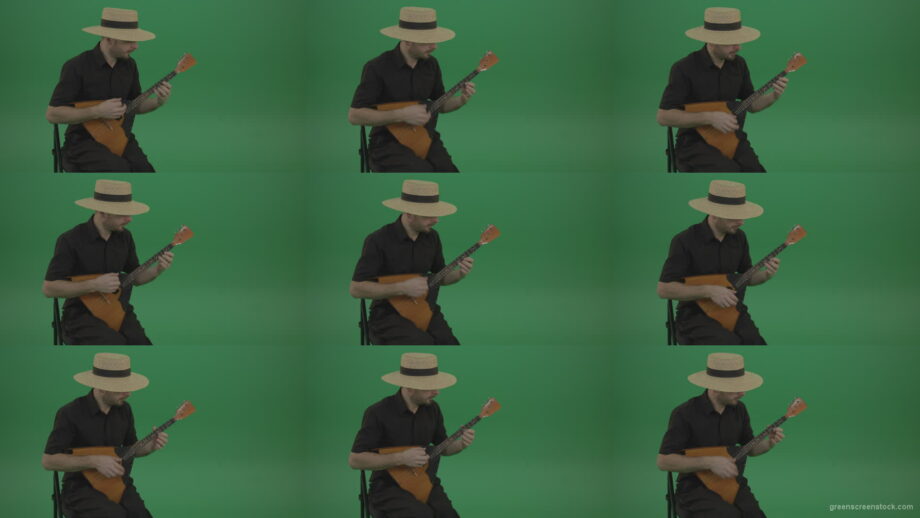 Village-guy-in-the-hat-plays-fun-on-the-balalaika Green Screen Stock