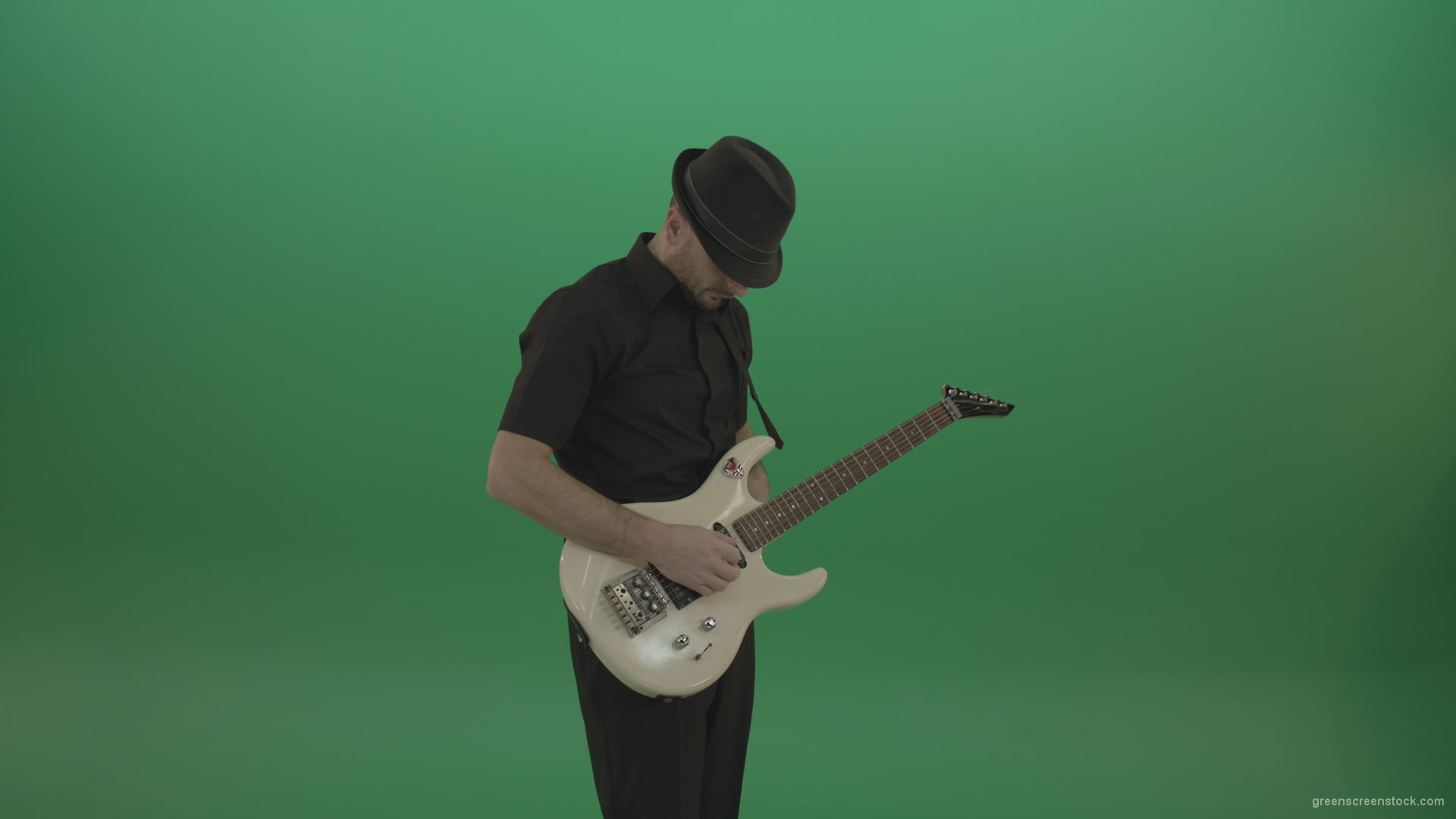 Virtuoso-guitarist-in-black-costume-and-hat-playing-solo-on-white-electro-guitar-siolated-on-green-screen_001 Green Screen Stock