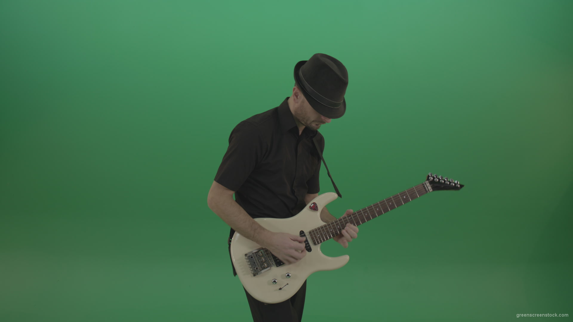 Virtuoso-guitarist-in-black-costume-and-hat-playing-solo-on-white-electro-guitar-siolated-on-green-screen_009 Green Screen Stock