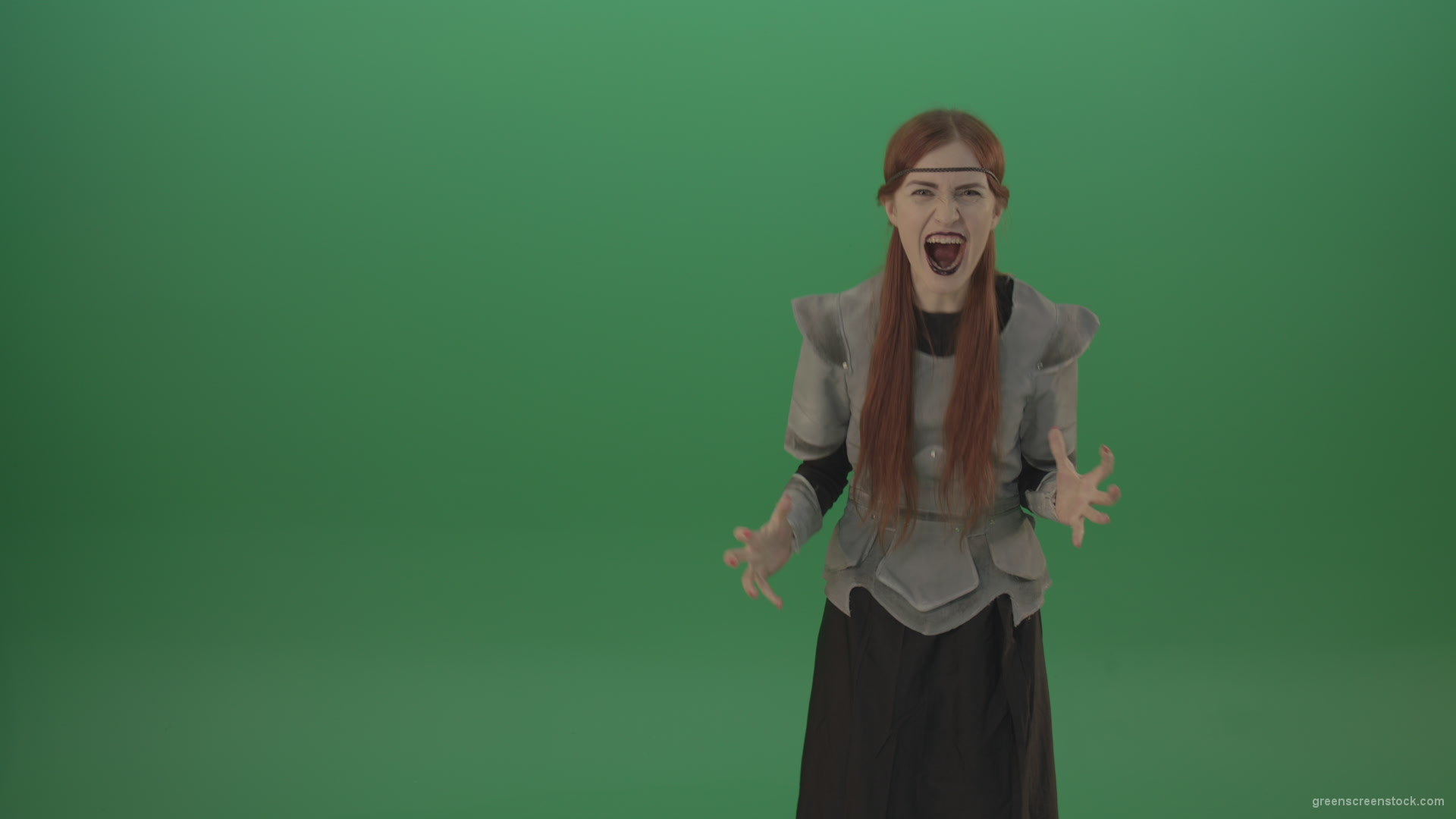 Witch-girl-watched-and-screamed-at-the-camera-with-green-eyes-on-a-green-background_007 Green Screen Stock