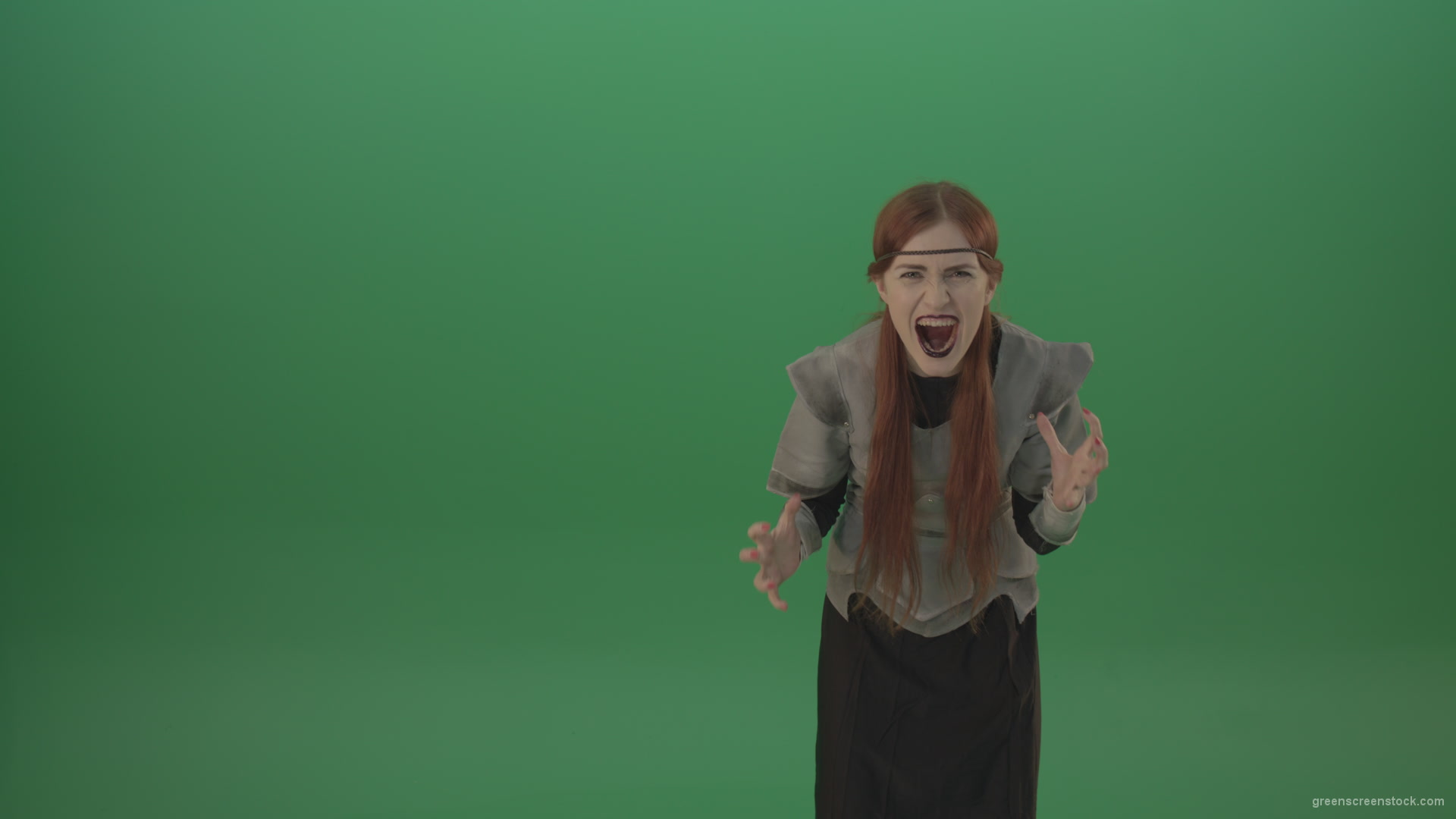 Witch-girl-watched-and-screamed-at-the-camera-with-green-eyes-on-a-green-background_008 Green Screen Stock
