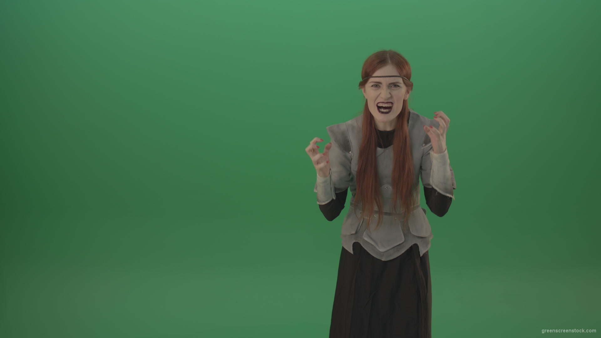 Witch-girl-watched-and-screamed-at-the-camera-with-green-eyes-on-a-green-background_009 Green Screen Stock