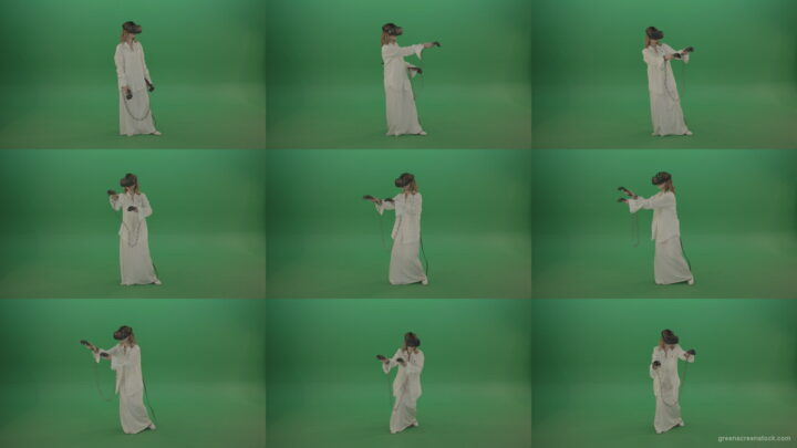 Girl-in-a-white-spacious-dress-is-wearing-glasses-of-virtual-reality-isolated-on-green-background Green Screen Stock