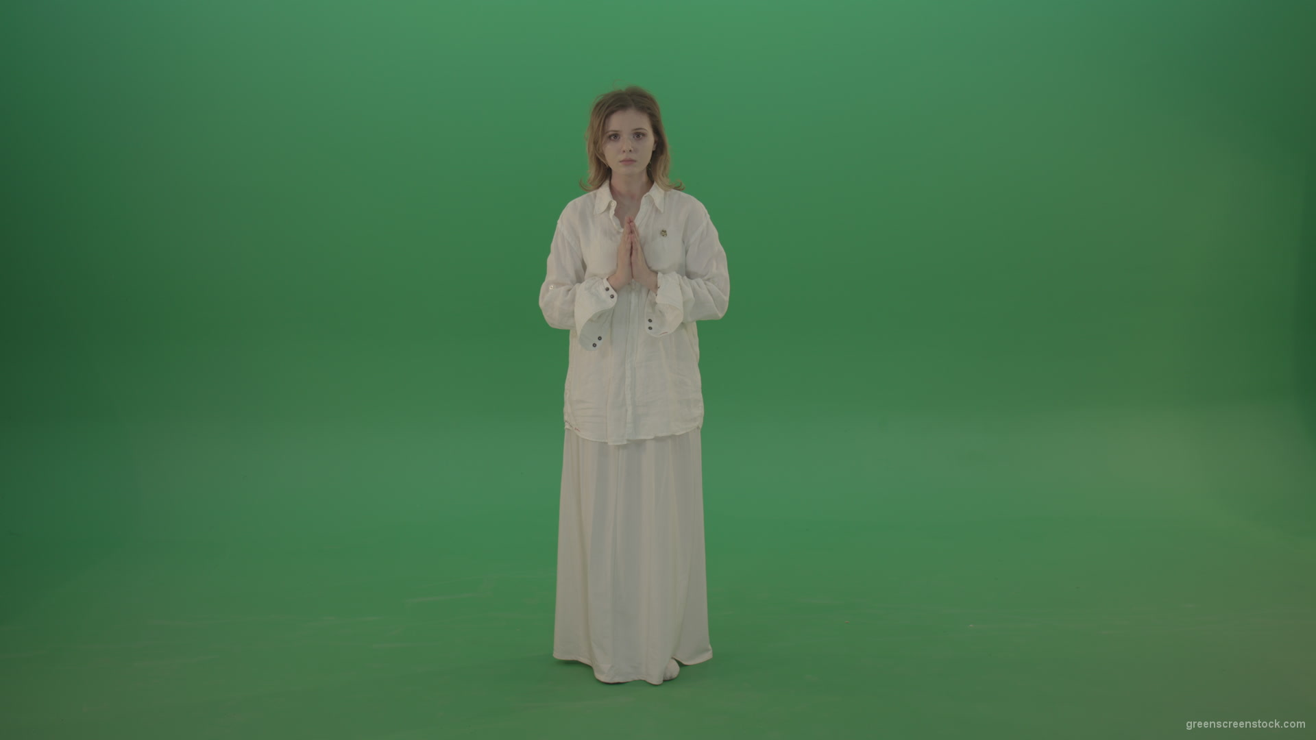 Girl-wearing-a-white-suit-pray-to-god-isolated-on-green-background_002 Green Screen Stock