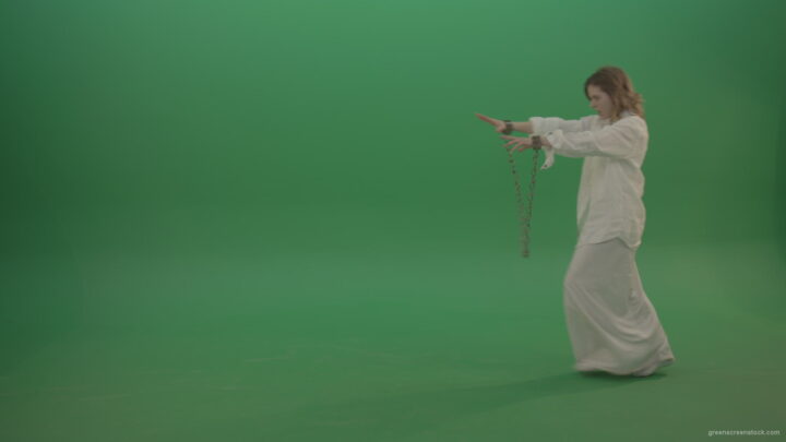 Zombie-woman-in-chains-slowly-goes-away-isolated-in-green-screen-studio_005 Green Screen Stock