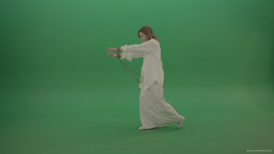 Zombie-woman-in-chains-slowly-goes-away-isolated-in-green-screen-studio_006 Green Screen Stock
