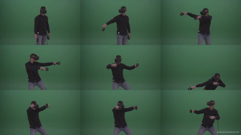 Young_Dangerous_Brunette_Man_Wearing_Black_Shirt_Shooting_Enemies_All_Around_In_Virtual_Reality_Glasses_Green_Screen_Wall_Background Green Screen Stock