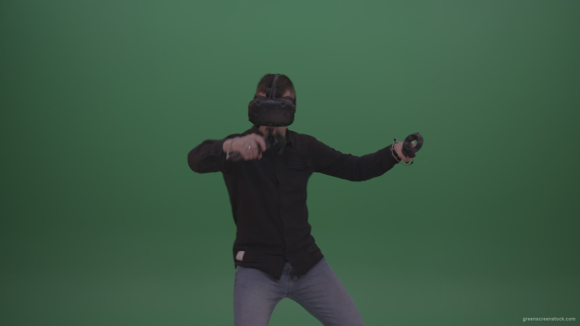 Young_Dangerous_Brunette_Man_Wearing_Black_Shirt_Shooting_Enemies_All_Around_In_Virtual_Reality_Glasses_Green_Screen_Wall_Background_005 Green Screen Stock