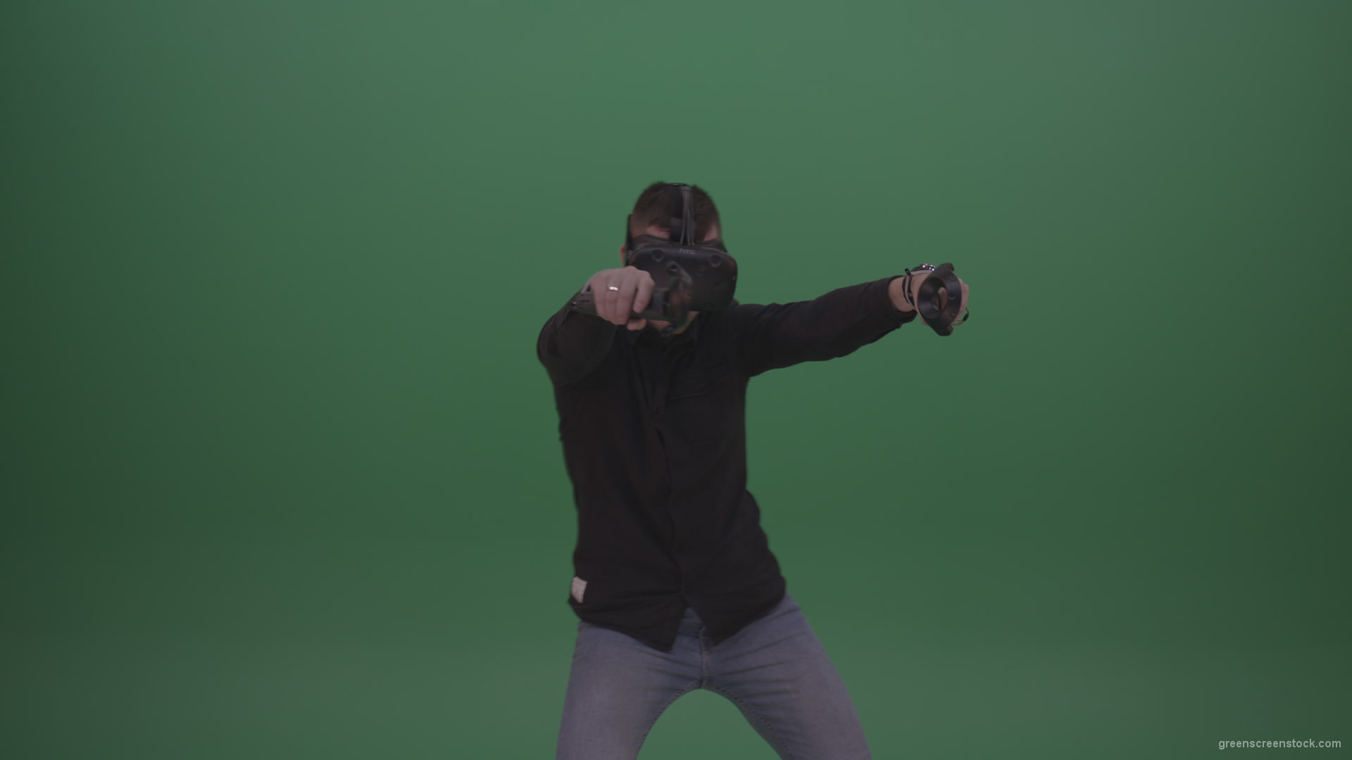 Young_Dangerous_Brunette_Man_Wearing_Black_Shirt_Shooting_Enemies_All_Around_In_Virtual_Reality_Glasses_Green_Screen_Wall_Background_008 Green Screen Stock