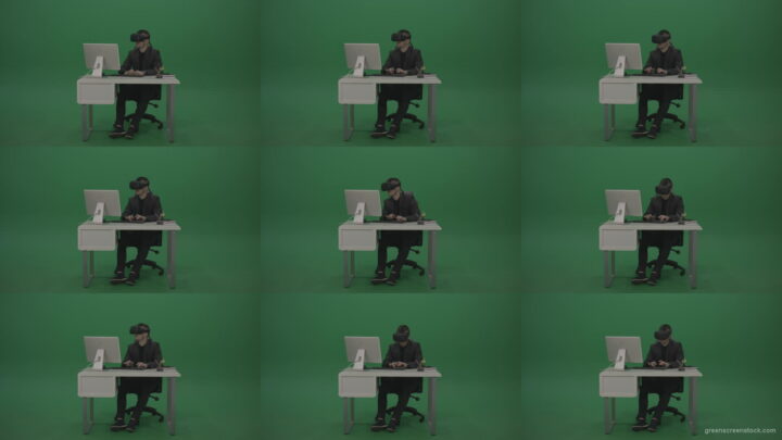 Young_Handsome_Businessman_Wearing_Dark_Suite_Sitting_At_The_Office_Table_Typing_Message_Using_VR_Glasse_Green_Screen_Wall-1920 Green Screen Stock