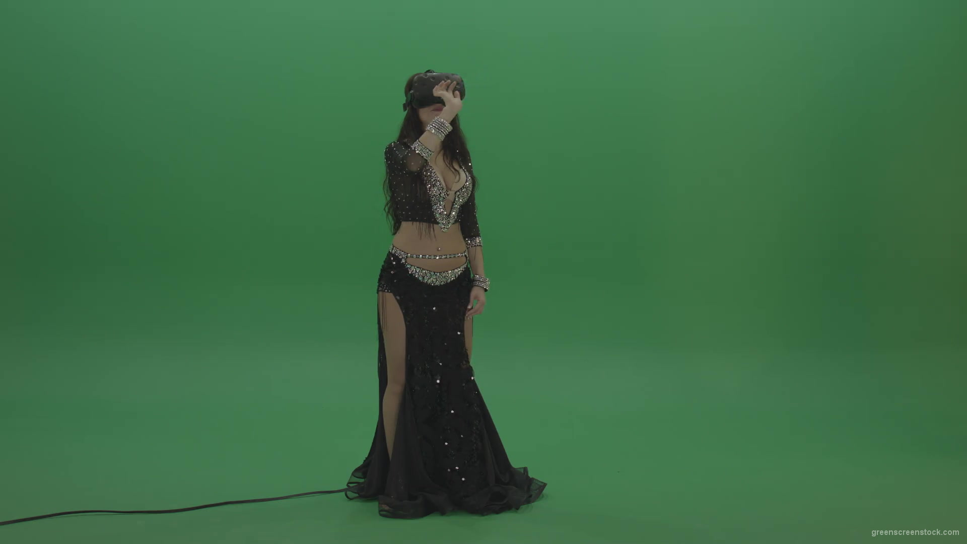 Beautiful-belly-dancer-in-VR-headset-operates-invisible-screen-over-green-screen-background-1920_006 Green Screen Stock