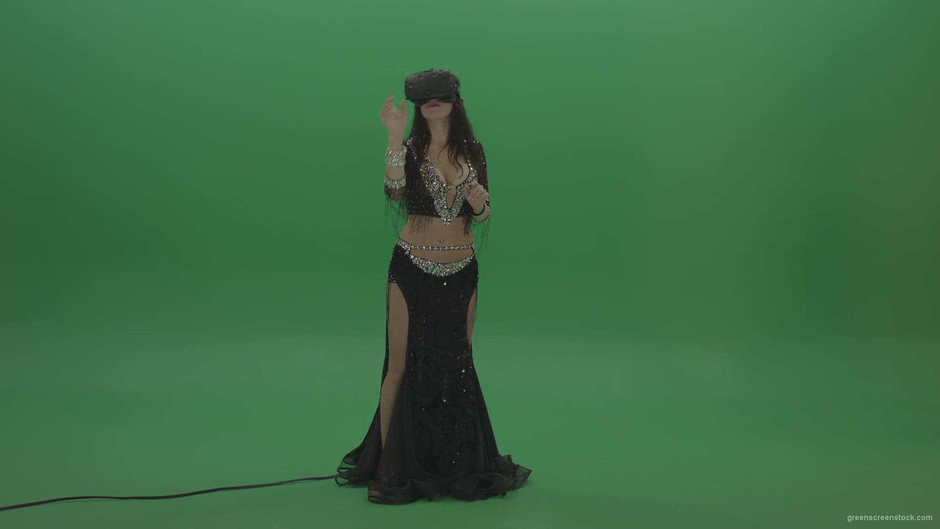 Beautiful-belly-dancer-in-VR-headset-operates-invisible-screen-over-green-screen-background-1920_009 Green Screen Stock
