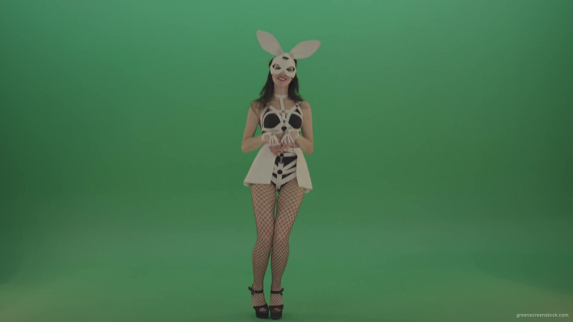 Happy-girl-dressed-in-rabbit-costume-for-adults-cyclically-jumping-in-different-directions-with-white-ears-on-chromakey-background-1920_008 Green Screen Stock