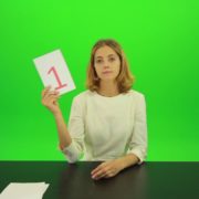 Blonde-girl-adult-gives-1-one-point-mark-score-Full-HD-Green-Screen-Video-Footage_004 Green Screen Stock