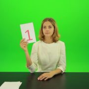 Blonde-girl-adult-gives-1-one-point-mark-score-Full-HD-Green-Screen-Video-Footage_005 Green Screen Stock