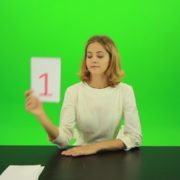 Blonde-girl-adult-gives-1-one-point-mark-score-Full-HD-Green-Screen-Video-Footage_008 Green Screen Stock