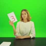 Blonde-hair-girl-in-white-shirt-give-3-point-mark-score-Full-HD-Green-Screen-Video-Footage_004 Green Screen Stock