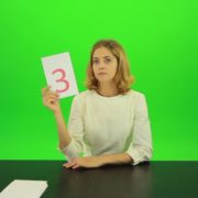 Blonde-hair-girl-in-white-shirt-give-3-point-mark-score-Full-HD-Green-Screen-Video-Footage_005 Green Screen Stock