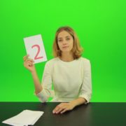 Blonde-shy-jury-gives-two-2-points-mark-Full-HD-Green-Screen-Video-Footage_006 Green Screen Stock