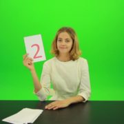 Blonde-shy-jury-gives-two-2-points-mark-Full-HD-Green-Screen-Video-Footage_008 Green Screen Stock