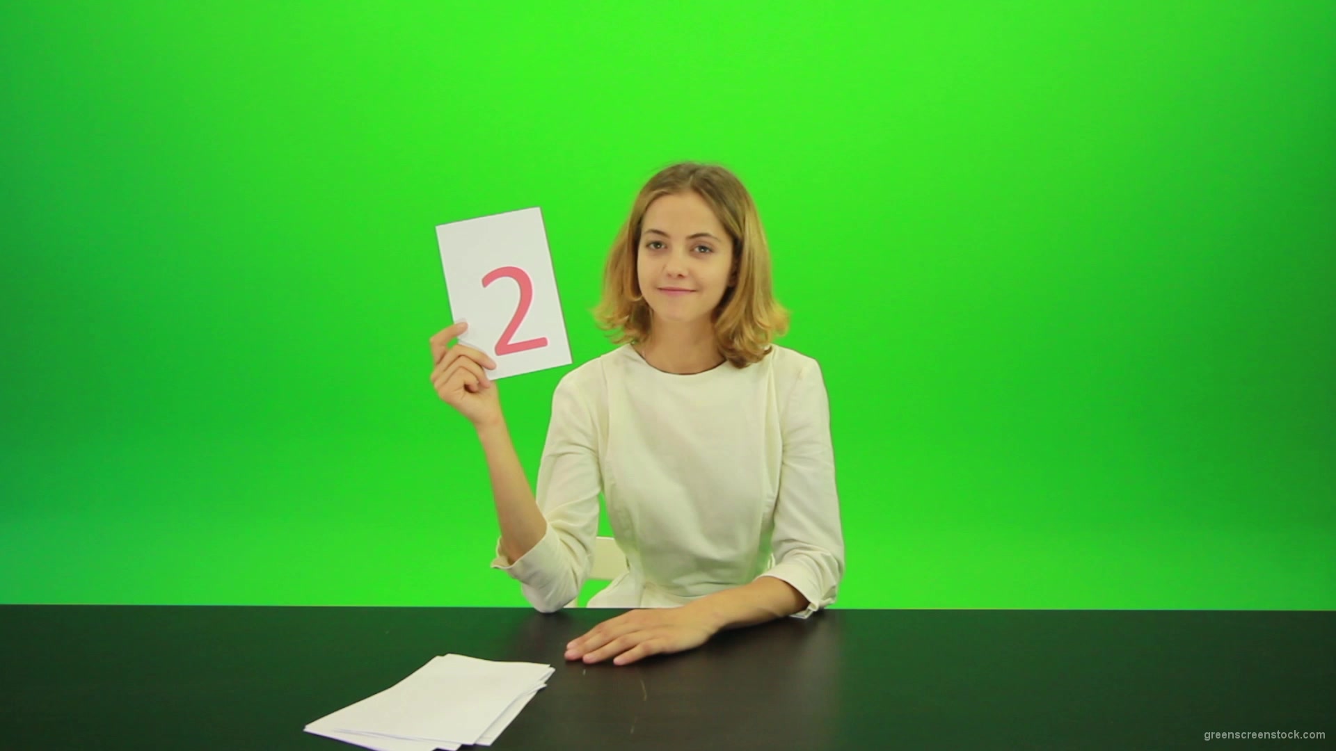 Blonde-shy-jury-gives-two-2-points-mark-Full-HD-Green-Screen-Video-Footage_008 Green Screen Stock