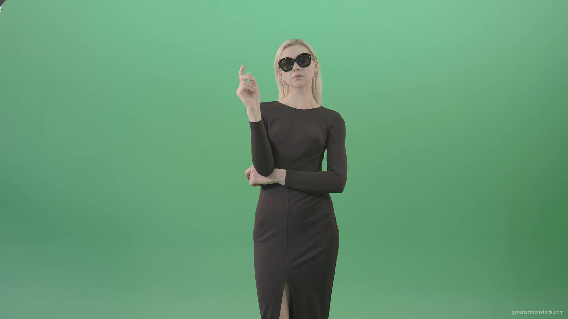 Elegant-woman-in-black-suite-searching-a-virtual-products-on-touch-screen-in-green-screen-studio-4K-Video-Footage-1920_005 Green Screen Stock