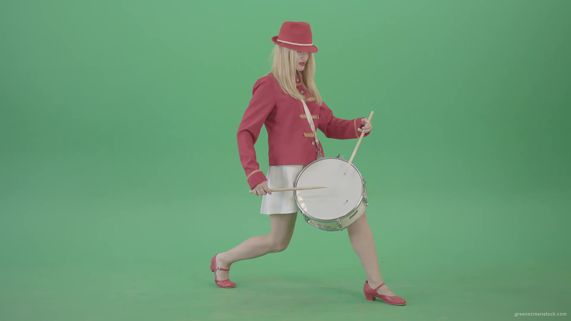 Blonde-Girl-in-Red-Uniform-making-beats-on-music-drum-instrument-in-active-pose-on-green-screen-4K-Video-Footage-1920_001 Green Screen Stock