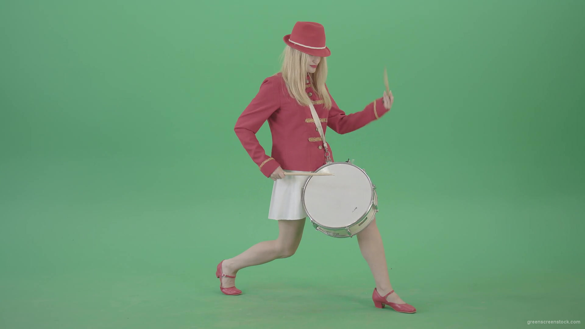 Blonde-Girl-in-Red-Uniform-making-beats-on-music-drum-instrument-in-active-pose-on-green-screen-4K-Video-Footage-1920_006 Green Screen Stock
