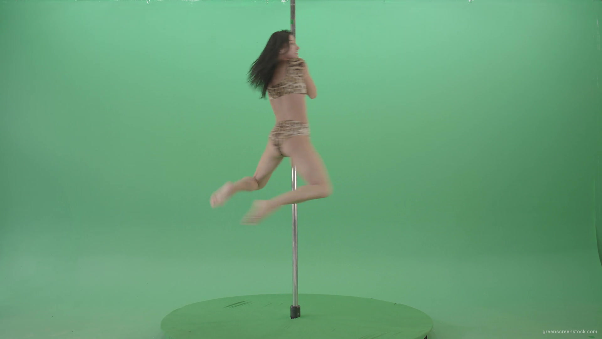 Slim-woman-spinning-in-simple-pose-dancing-pole-dance-in-animal-jaguar-skin-underwear-on-green-screen-4K-Video-Footage-1920_005 Green Screen Stock