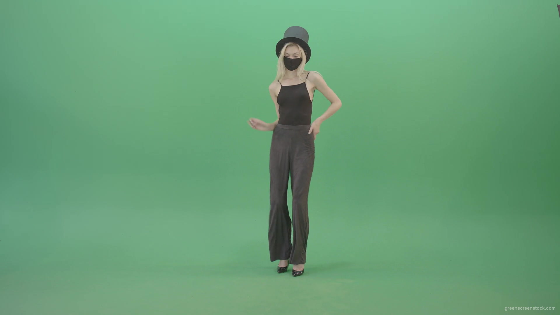 Blonde-Girl-in-Black-Cylinder-Hat-dancing-slowly-in-Corona-VIrus-Mask-on-green-screen-VIdeo-Footage-1920_002 Green Screen Stock