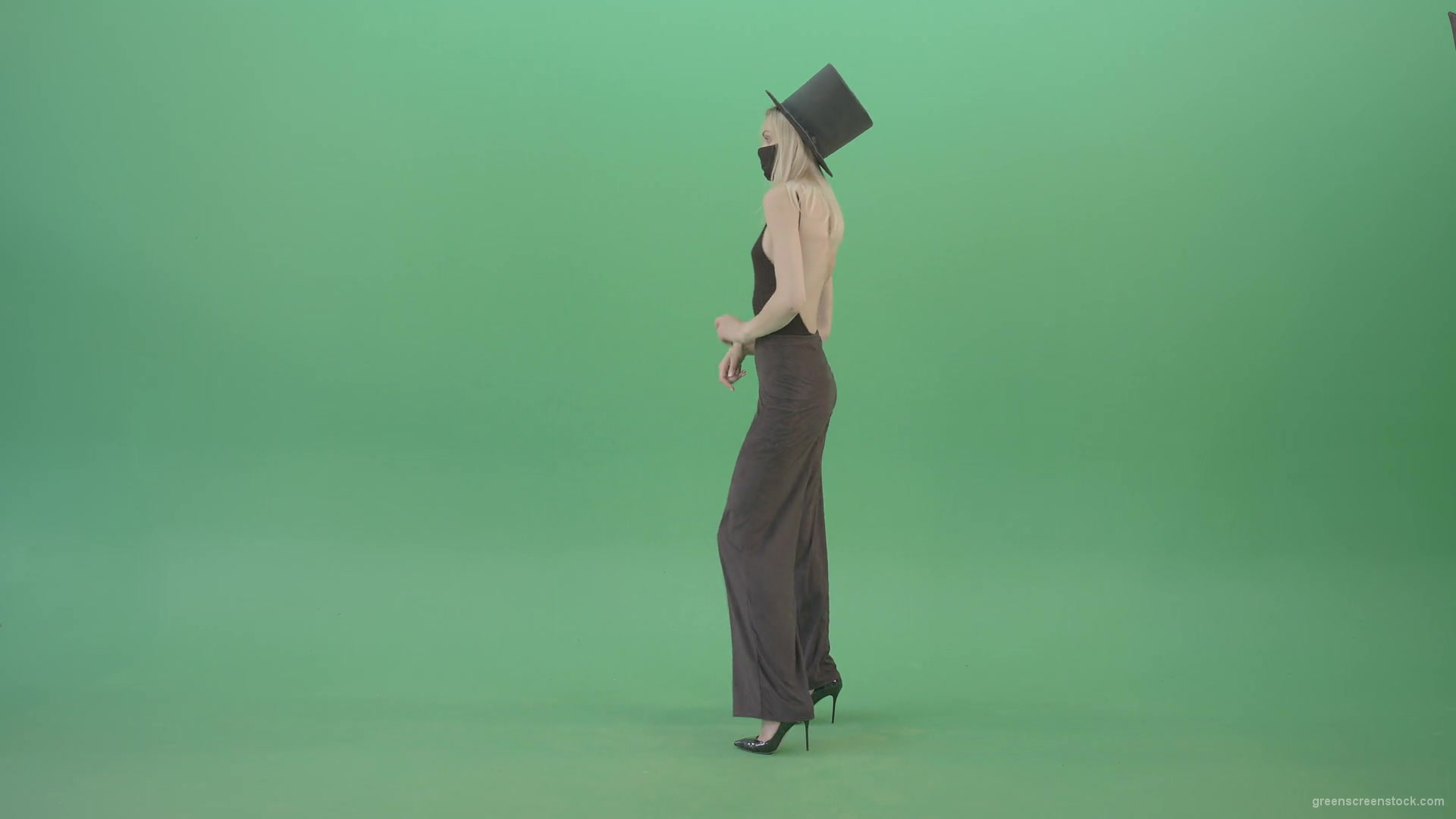 Blonde-Girl-in-Black-Cylinder-Hat-dancing-slowly-in-Corona-VIrus-Mask-on-green-screen-VIdeo-Footage-1920_008 Green Screen Stock